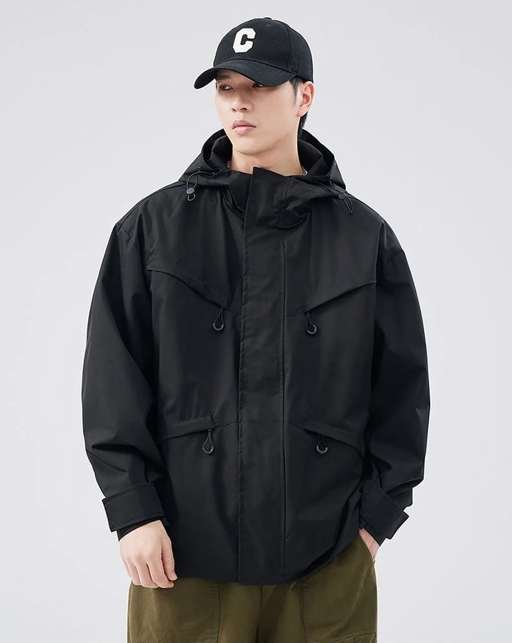 Waterproof Solid Color Raincoat Featuring a Drawstring Hem and Cargo Pockets